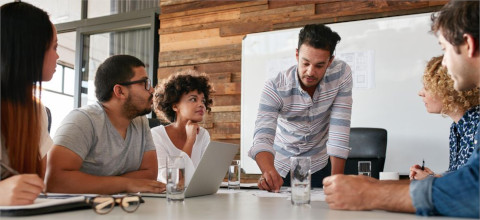 Image of modern office workers at a conference table
