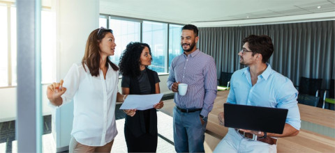 Stock image of an office setting with three workers